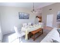 Bright dining area features a chandelier and seating for six at the table and bench at 1894 E Sagebrush St, Gilbert, AZ 85296