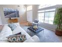Bright living room features high ceilings, a large window, and stylish contemporary furnishings at 1894 E Sagebrush St, Gilbert, AZ 85296