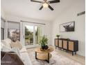 Cozy living room with a sliding glass door leading to a balcony, and a decorative console table at 2035 S Elm St # 211, Tempe, AZ 85282