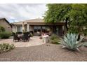 Serene backyard with covered patio, paver patio, agave, and desert landscaping at 20669 N 266Th Ave, Buckeye, AZ 85396