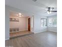 Open-concept living room with new floors, light colored walls and a beautiful view from a large window at 2502 S Mollera Cir, Mesa, AZ 85210