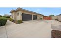 Large three car garage with automatic doors and spacious driveway at 2735 E King Bird Dr, Gilbert, AZ 85297