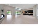 A spacious living room with a modern fireplace, plenty of natural light, and high ceilings at 2735 E King Bird Dr, Gilbert, AZ 85297
