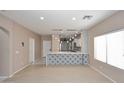 Bright, open-concept living room features hardwood floors and modern fixtures, ideal for entertaining at 36950 W Mondragone Ln, Maricopa, AZ 85138