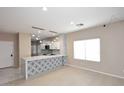The bright living room offers an open floor plan and scenic windows at 36950 W Mondragone Ln, Maricopa, AZ 85138