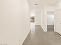 Bright hallway featuring ceramic tile flooring and white walls leading into the house at 37125 W Prado St, Maricopa, AZ 85138