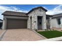 Inviting single-Gathering home with stone accents, a spacious garage, and a well-paved driveway, designed for comfort at 3738 E Rochelle Cir, Mesa, AZ 85213