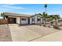 Attractive single-story residence with desert landscaping, a covered carport, and mature palm trees at 407 E Orion St, Tempe, AZ 85283