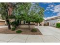 Charming single-story home featuring a well-manicured lawn, a two-car garage, and a cozy front porch at 4273 S Red Rock St, Gilbert, AZ 85297