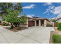Charming single-story home featuring a well-manicured lawn, a two-car garage, and a cozy front porch at 4273 S Red Rock St, Gilbert, AZ 85297