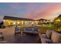 Expansive backyard with a well-manicured lawn, comfortable seating, and a refreshing pool, ideal for outdoor living at 5424 N 186Th Dr, Litchfield Park, AZ 85340
