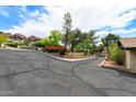 Expansive driveway with desert landscaping and mature trees at 5536 N Camelback Canyon Pl, Phoenix, AZ 85018