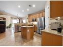 Spacious kitchen featuring an island, stainless steel appliances, and tile flooring at 641 W Mesquite Tree Ln, San Tan Valley, AZ 85143