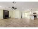 Open-concept living area features tile floors, a fireplace, and seamless access to the updated kitchen at 6821 W Mariposa St, Phoenix, AZ 85033