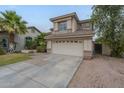 Two-story home with a two car garage, low maintenance landscaping, and driveway at 6858 W Potter Dr, Glendale, AZ 85308