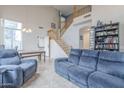 Open-concept living room with high ceilings, a staircase, and comfortable seating at 6858 W Potter Dr, Glendale, AZ 85308