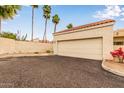 Exterior view of a two-car garage with a neutral door and well-maintained surroundings at 7101 W Beardsley Rd # 1403, Glendale, AZ 85308