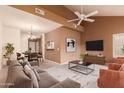 Open concept living room with modern furnishings and ample natural light, adjoining dining area at 7101 W Beardsley Rd # 1403, Glendale, AZ 85308