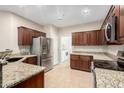 Well-lit kitchen featuring stainless steel appliances and granite countertops at 7516 S 31St Pl, Phoenix, AZ 85042