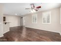 Bright living room with hardwood floors, a ceiling fan, and large windows at 7516 S 31St Pl, Phoenix, AZ 85042