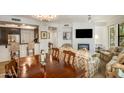 Open-concept living room and dining area with a fireplace, television, and comfortable seating at 7601 E Indian Bend Rd # 1050, Scottsdale, AZ 85250