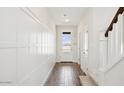 Bright hallway with wood-look tile floors and classic white wainscoting at 8047 W Griswold Rd, Peoria, AZ 85345