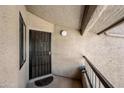 Close up of condo entrance, security door, and unit number at 9450 N 94Th Pl # 214, Scottsdale, AZ 85258