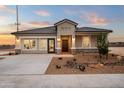 Attractive single-story home featuring desert landscaping, neutral paint, and a spacious driveway at 10035 S Palo Verde Dr, Apache Junction, AZ 85120