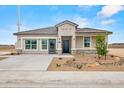 Inviting single-story home with desert landscaping, neutral paint, and spacious driveway at 10035 S Palo Verde Dr, Apache Junction, AZ 85120
