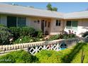 Home featuring a charming garden, complemented by a secure home security system and mature landscaping at 10229 W Bolivar Dr, Sun City, AZ 85351