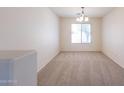 Dining area with neutral carpet, white walls, and a window for natural light at 11357 W Buchanan St, Avondale, AZ 85323