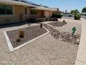 Unique desert landscaping featuring creative design elements, decorative rock and drought tolerant plants at 11415 N 110Th Dr, Sun City, AZ 85351