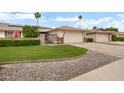 Charming single-story home featuring a well-manicured lawn and a two car garage at 12542 W Parkwood Dr, Sun City West, AZ 85375