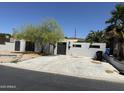 Cozy white-walled home featuring desert landscaping and a spacious concrete driveway at 1524 E Cortez St, Phoenix, AZ 85020