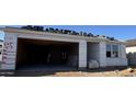 New home construction showing garage, doorway and stacked roof tiles at 15788 W Beryl Ave, Waddell, AZ 85355