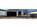 New home construction with a large garage and stacked roof tiles at 15788 W Beryl Ave, Waddell, AZ 85355
