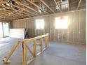 Unfinished living room area with two windows and sliding glass door at 15788 W Beryl Ave, Waddell, AZ 85355