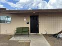 Secured front entrance with black security door and outdoor seating bench at 1802 W Frier Dr, Phoenix, AZ 85021