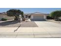 Charming home featuring a tile roof, low-maintenance desert landscaping, and a two-car garage at 19507 N Hidden Canyon Dr, Surprise, AZ 85374