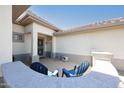 Inviting front porch with seating and charming details that create a welcoming entrance to the home at 19507 N Hidden Canyon Dr, Surprise, AZ 85374
