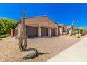 Spacious three-car garage with stone driveway, desert landscaping and blue sky at 2011 W Calle De Las Estrella --, Phoenix, AZ 85085