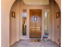 Inviting front entryway with beautiful wood door, sidelights, and covered porch at 2011 W Calle De Las Estrella --, Phoenix, AZ 85085