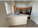 Bright kitchen with quartz countertops, wooden cabinets, and stainless steel appliances at 20275 N 81St Ln, Peoria, AZ 85382