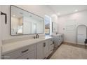 Modern bathroom with dual sinks, vanity, large mirrors, and walk-in shower at 20834 W Prospector Way, Buckeye, AZ 85396