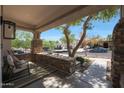 Welcoming front porch with stone accents, neutral stucco, and comfortable seating area at 20834 W Prospector Way, Buckeye, AZ 85396