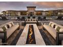 Resort-style community pool with lounge chairs, sofas, outdoor fire pit, and modern clubhouse for gatherings at 2121 W Sonoran Desert Dr # 43, Phoenix, AZ 85085