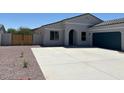Inviting single-level home featuring a well-manicured front yard and a private gated entrance at 2512 N Pony Ln, Casa Grande, AZ 85122