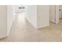 Neutral tile flooring runs throughout the hallway, providing a clean and modern aesthetic at 37154 W La Paz St, Maricopa, AZ 85138