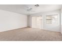 Spacious living room with carpet flooring, natural light, and access to the patio at 3728 W Fremont Rd, Phoenix, AZ 85041