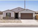 Charming single-story home featuring neutral stucco, a tile roof and a two-car garage at 37385 W San Sisto Ave, Maricopa, AZ 85138